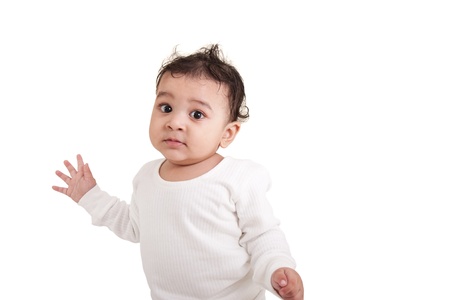 Adorable Indian baby playing with over white backgroundの写真素材