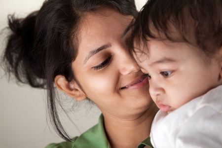 Indian Happy mother and baby looking at othersの写真素材