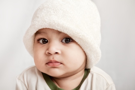 Indian curious boy baby looking at the camera on white background.の写真素材