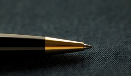 Black and  Golden ball Pen over textured backgroundの写真素材