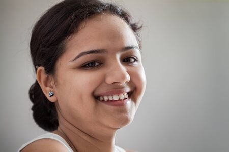 Portrait of happy young Asian woman, studio background の写真素材