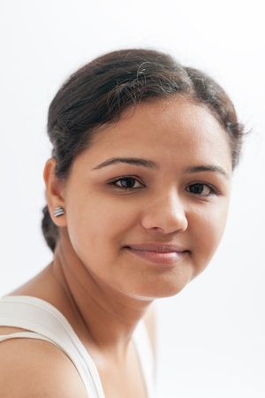 Attractive teenage indian girl smiling and looking down embarrassed の写真素材