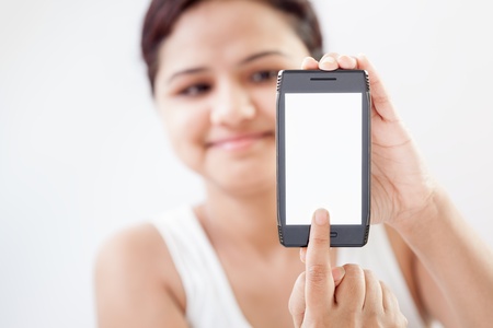 Indian modern girl showing touching screen mobile smart phone  Close-up imageの写真素材