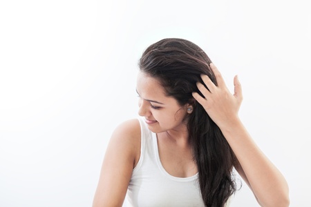 Young and beautiful Indian woman styling her hairの写真素材