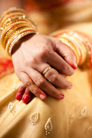 hand detail of indian bride with decorative bangle and gold ringの写真素材