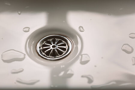 Modern water sink hole, stainless steel finish at bathroom sinkの写真素材