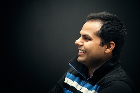 portrait of Indian man smiling and  wearing jacket