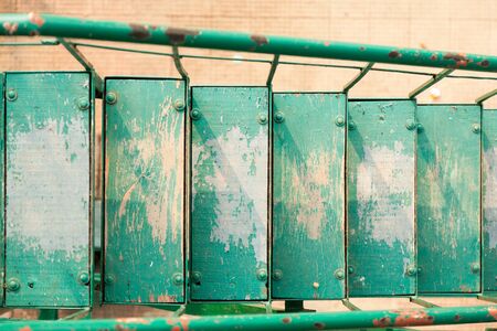 Old colorful wooden stairs with side rails of ironの写真素材