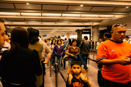 People waiting for immigration at Chek Lap Kok, Hong Kong International Airport. Hong Kong SAR, 20 June, 2013のeditorial素材