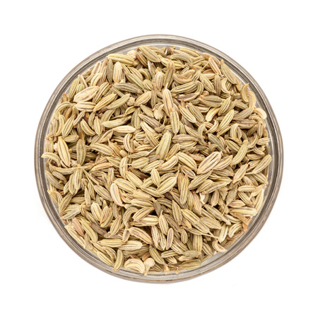 Top view of Organic Fennel seed Foeniculum Vulgare in glass bowl isolated on white background.の写真素材