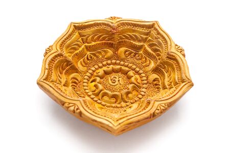 Close up of a beautifully carved designer handmade clay lamp isolated on white background.の写真素材