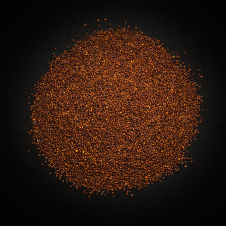 Top view of Organic Small Brown Mustard Seeds Brassica juncea isolated on dark background.の写真素材