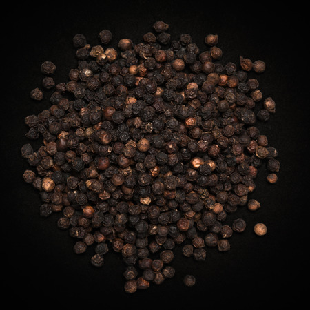 Top view of Organic Black pepper Piper nigrum isolated on dark background.の写真素材