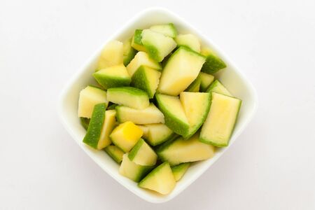 Organic sliced Indian Mango (Mangifera indica), in white bowl. Isolated on white background.Top view.の写真素材