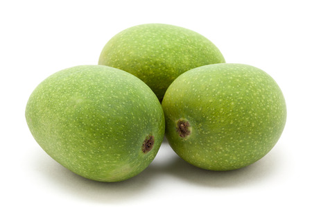 Three Organic green Indian Mangoes (Mangifera indica) isolated on white background. Front view.の写真素材