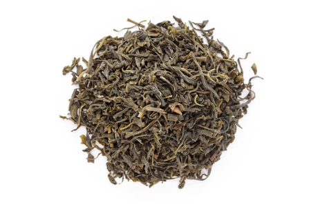 Organic Green Tea (Camellia sinensis) dried long leaves isolated on white background. Macro close up. Top view.の写真素材