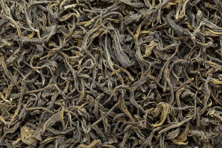 Organic Green Tea (Camellia sinensis) dried long leaves. Macro close up background texture. Top view.の写真素材