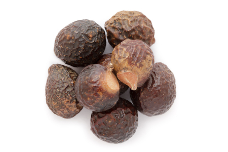 Organic Chinese soapberry or Reetha (Sapindus mukorossi) seeds. Isolated on white background. Macro close up. Top view.の写真素材