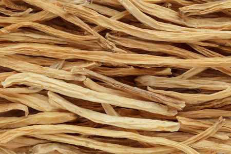 Organic dry shatavari (Asparagus racemosus) sticks. Macro close up background texture. Top view.の写真素材