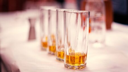 Close of Four Whiskey Glasses, shallow depth of field, creative lighting.の写真素材