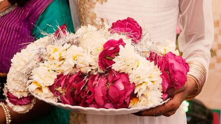 Flowers on plate during Garland Ceremony in Indian wedding.