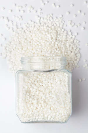 organic white  sago or sabudana big size, spilled and in a glass jar, Top view