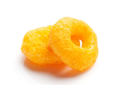 Popular Ready to eat crunchy and puffed snacks ring tangy orange color over white background