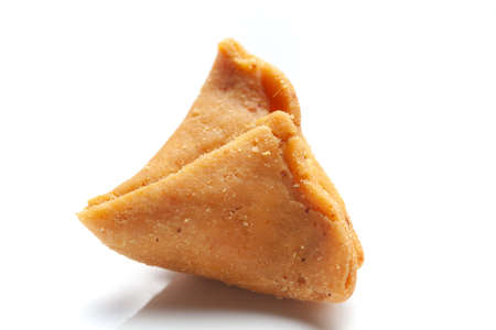 Close-up of freshly baked spicy and sweet samosa filled with dry fruits spicy dry chutney...