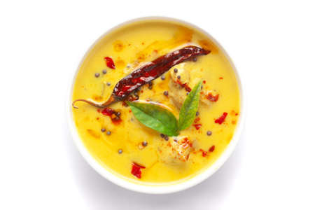 Close-up of Indian traditional kadhi or kadi pakora yogurt and gram flour and turmeric served hot in...