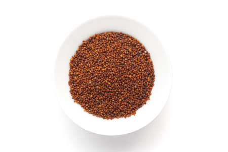 Macro close-up of Organic red-brown small mustard seed (Brassica nigra)  on white background. Pile of Indian Aromatic Spice. Top viewの写真素材