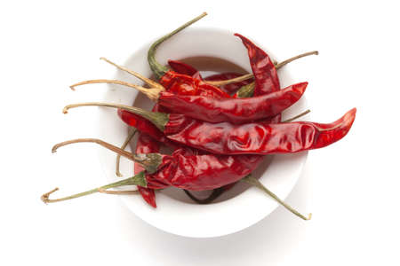 Macro close-up of Organic red chili pepper( Capsicum annuum)  on white background. Pile of Indian...