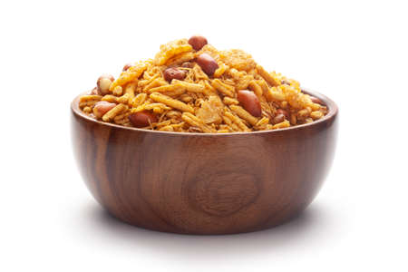 Close-Up of Spicy Chatpata Mixture In hand-made (handcrafted) wooden bowl made with peanuts, corn flakes. Indian spicy snacks (Namkeen)の写真素材