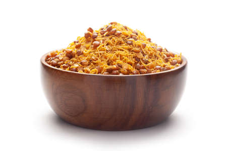 Close-Up Dal Bijli or Dal moth In hand-made (handcrafted) wooden bowl, made with roasted Masoor Dal (black lentils). Indian spicy snacks (Namkeen)の写真素材