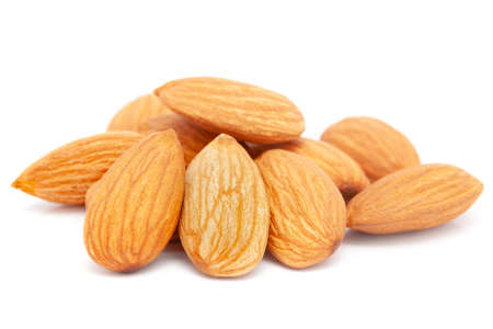 Micro close-up and details of Organic Indian brown almonds (Prunus dulcis) kernels isolated over white background.の写真素材