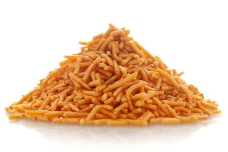 Close-up of Nimbu masala besan sev Indian namkeen (snacks),  Indian spicy snacks (Namkeen), in a pile or heap, isolated over white backgroundの写真素材