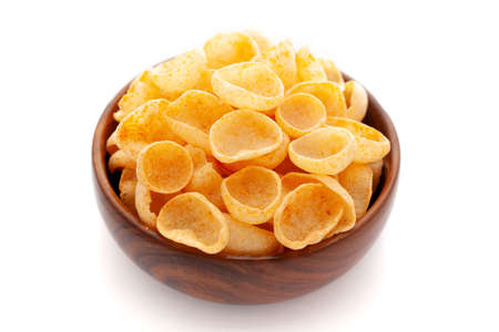 Close up of Cheese Puff Snacks cream color, Popular Ready to eat crunchy and puffed snacks cheesy salty pale-yellow color over white backgroundの写真素材
