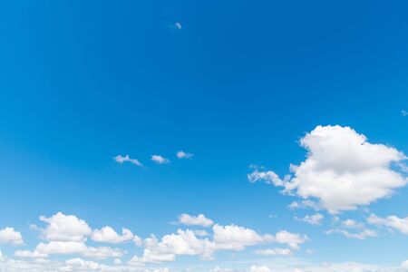 Blue sky with fluffy cloudsの写真素材