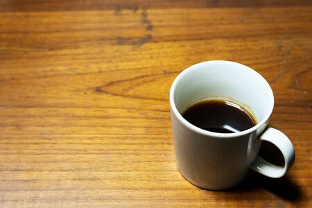 Old wood office desk table with cup of coffee - Top view with copy space.の写真素材