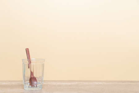 Glass and Wooden spoon with blank copy space for your design.の写真素材