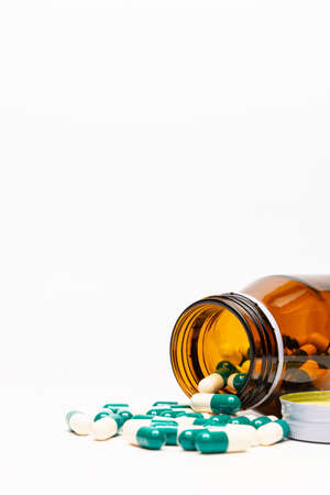 Amber Drug Bottle and Drug Capsule on White Background. No Isolated. No Cutout.