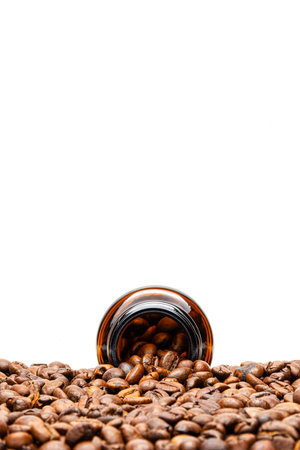 Isolated Roasted Arabica Coffee Beans and Glass Bottle on White Backgroundの写真素材
