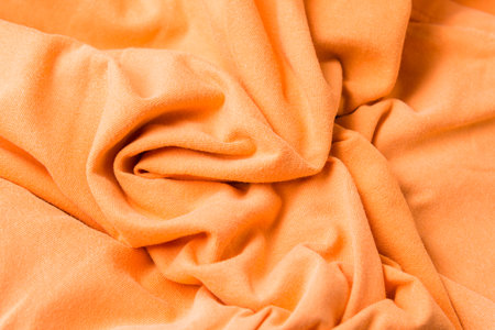 Close up textile texture of orange clothing wallpaper