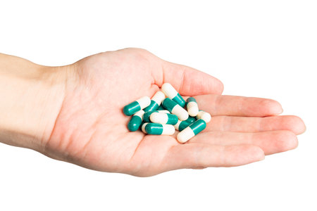 Cutout Human Hand Hold Drug Capsule on White Background.の写真素材