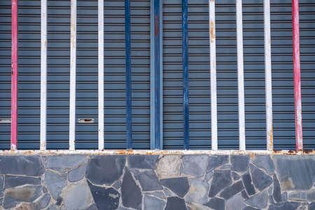 The steel grille was put together at the folding door in front of the community store. For safetyの写真素材