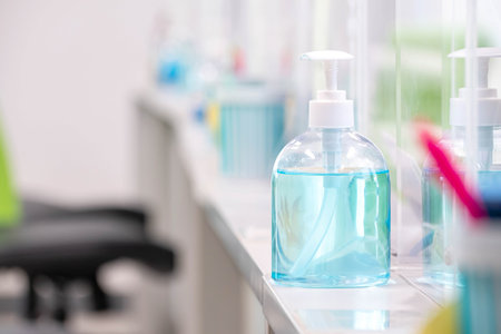 Blue alcohol gel bottle placed on the table to serve customers within a bank, measures to prevent the spread of respiratory viral diseaseの写真素材