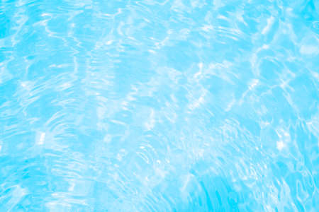 Blurred transparent blue colored clear calm water surface texture with splashes and bubbles. Trendy abstract nature background. Water waves in sunlight. water backgroundの写真素材