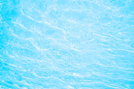 Blurred transparent blue colored clear calm water surface texture with splashes and bubbles. Trendy...