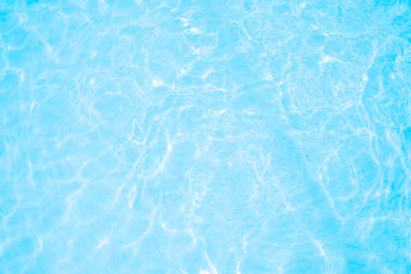 Blurred transparent blue colored clear calm water surface texture with splashes and bubbles. Trendy...