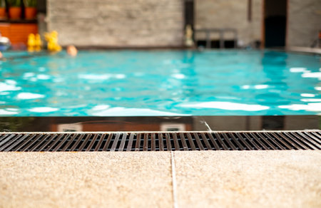 Black gutter is installed beside swimming pool, drainage system, overflow gutter, private pool, pool edge.の写真素材