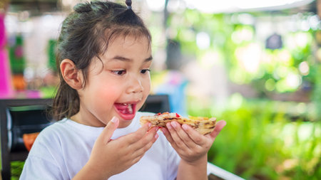 Asian girl wearing a white shirt and holding pizza slice Hawaiian traditional Italian crust thin crispy ham and pineapple pizza up stretching cheese ready, Junk foodの写真素材